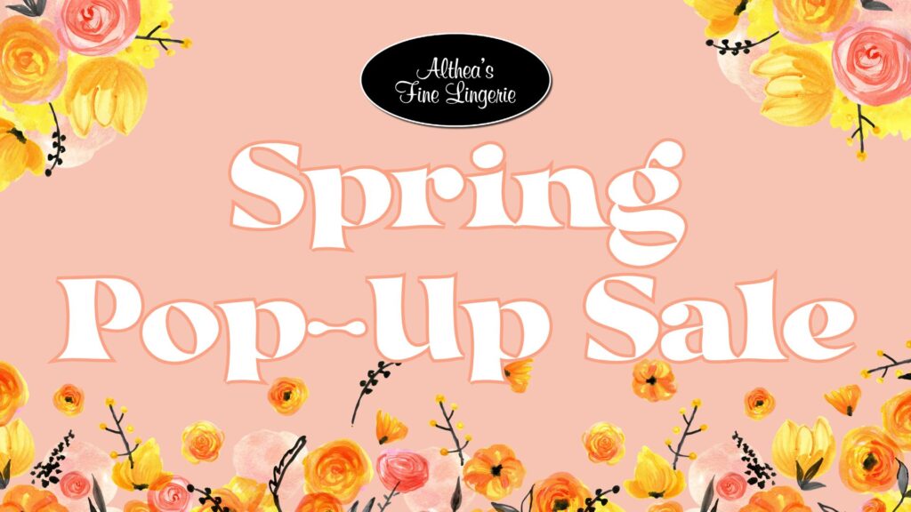 Promotional graphic for "Althea's Fine Lingerie Spring Pop-Up Sale." The background is a soft peach color with elegant white text outlined in a darker shade. Surrounding the text are watercolor-style floral illustrations featuring yellow, orange, and pink flowers with black stems and small accents. At the top, a black oval logo with white cursive text reads "Althea’s Fine Lingerie.