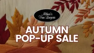 Althea’s Fine Lingerie Autumn Pop-Up Sale graphic with embroidered fall leaves in red, gold, and orange tones, promoting seasonal lingerie sale in Milwaukee.